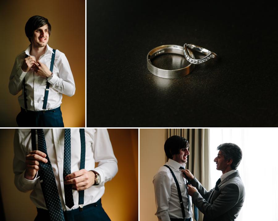 Groomsmen helping the groom with his tie