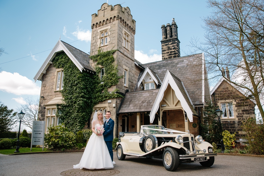Bride and groom with the wedding car at West tower