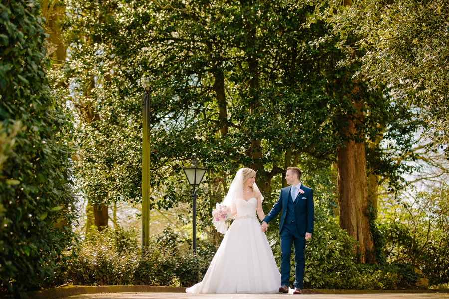 Bride and groom walking together in the sun