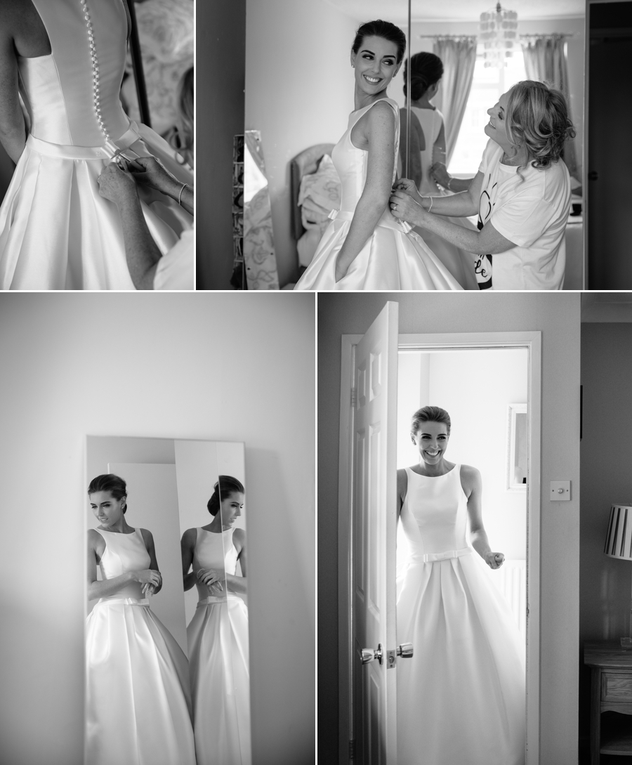 The Mother of the Bride helping her daughter put on her wedding dress