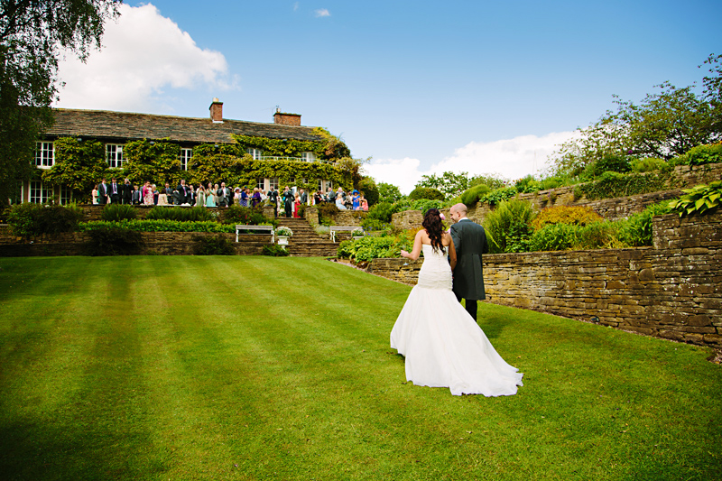 Bride and Groom walking in the garden at Hilltop