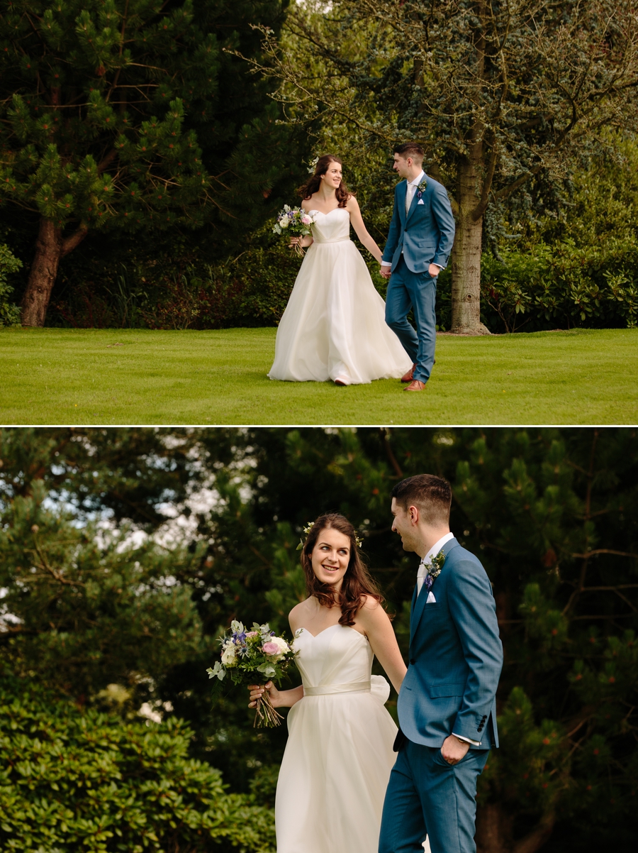 Bride and Groom walking through the gardens at Holford Estate