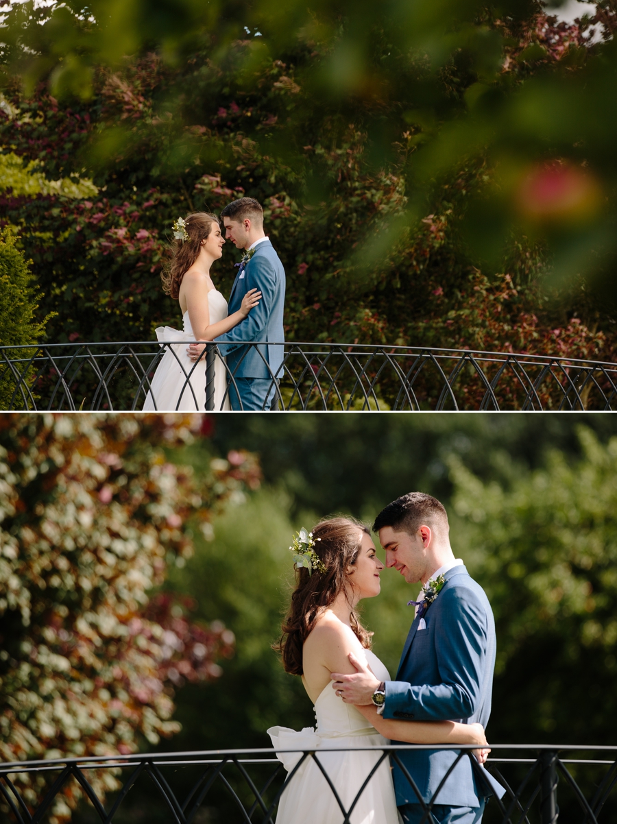 Bride and Groom having a cuddle on a bridge over a stream