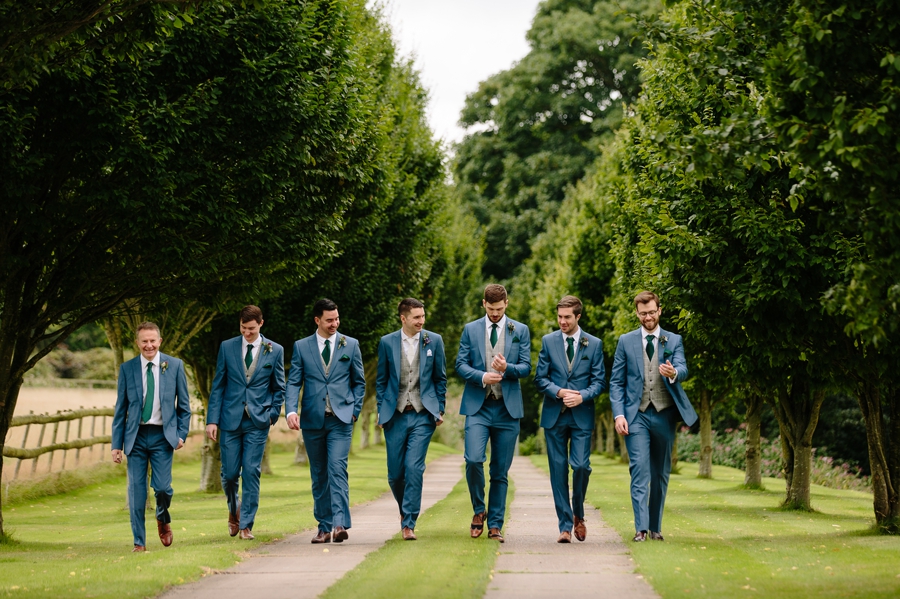 The Groom and Groomsmen walking up the lane to the ceremony 