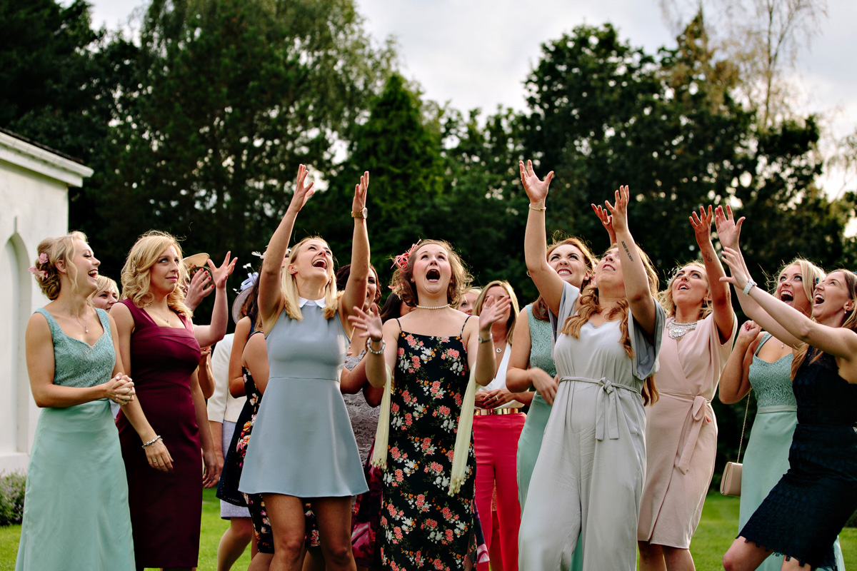 All the girls laughing and trying to catch the wedding bouquet