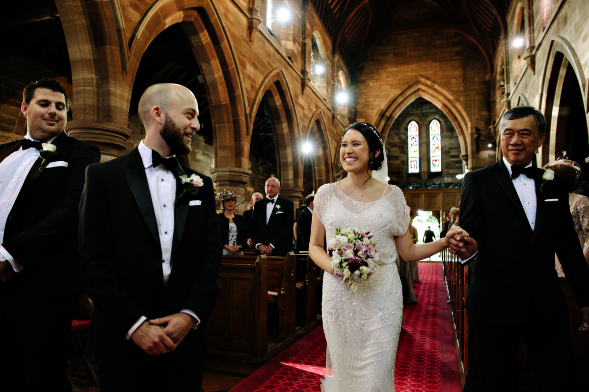 Groom seeing the Bride for the first time as she walks down the aisle in the church