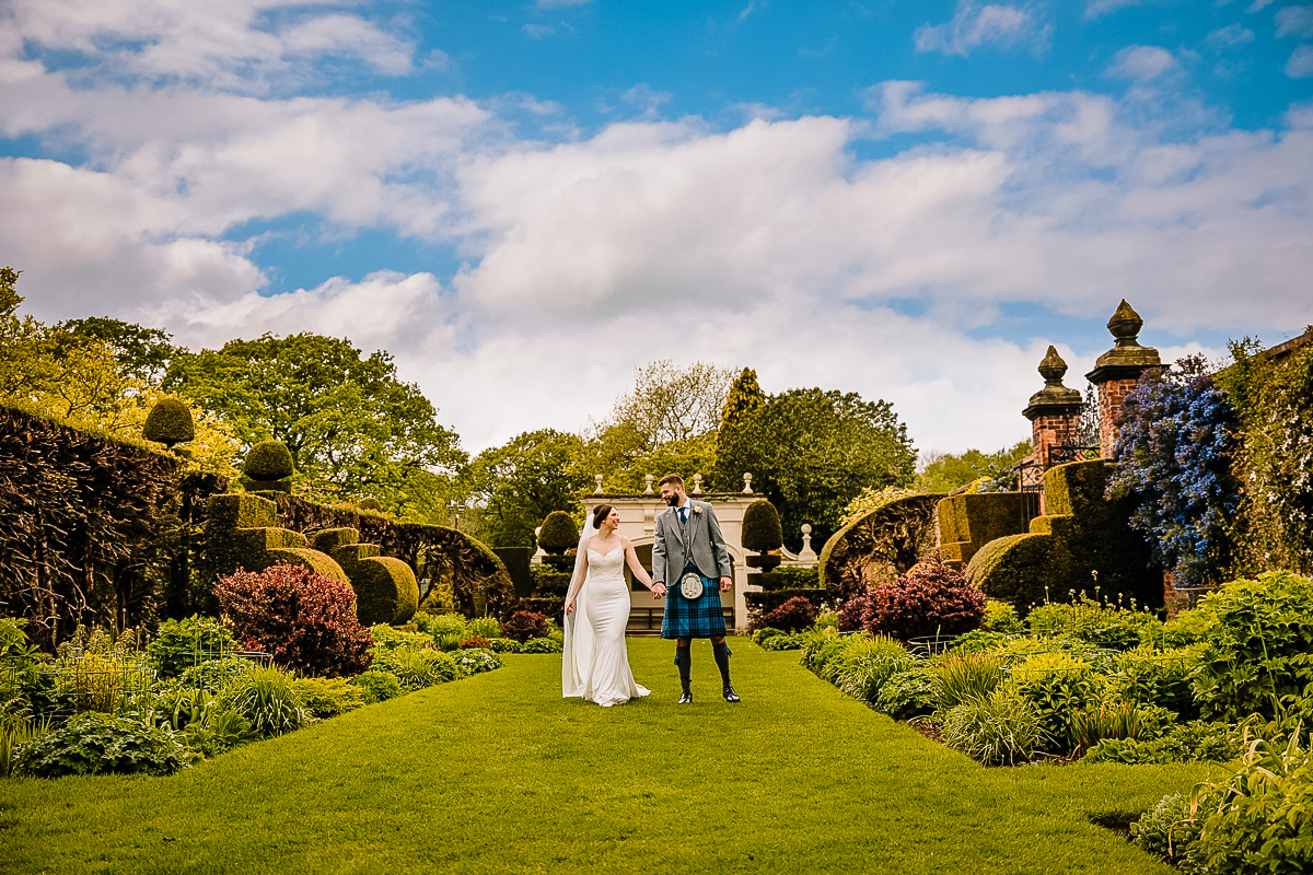 Bride and Groom photographed walking in the stunning gardens at Arley Hall and Gardens
