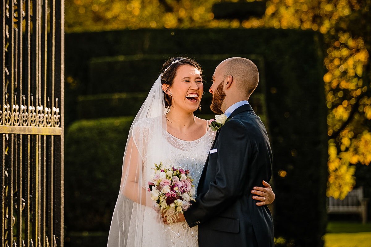 Bride and Groom having fun in the gardens at Arley Hall and gardens