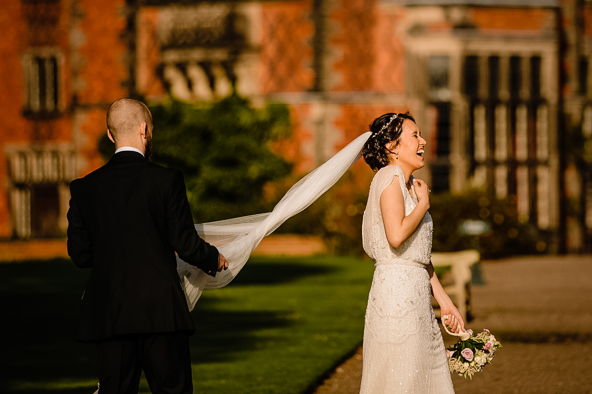 Bride and groom laughing at Arley Hall wedding