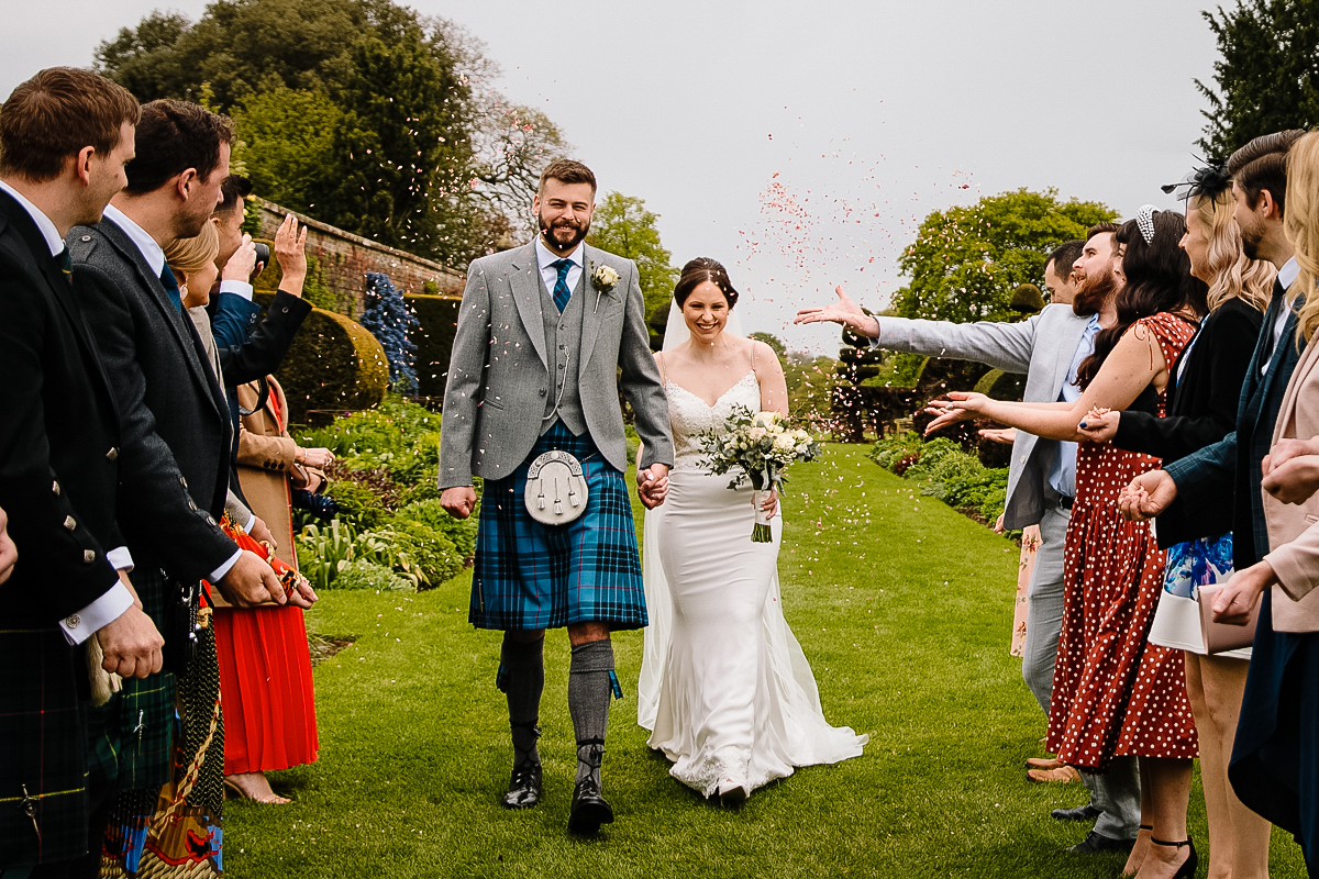 Arley Hall couple having confetti thrown at them in the stunning gardens