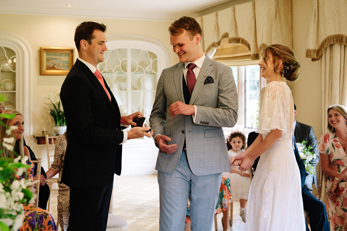 Best man hands over the wedding rings at Colshaw Hall