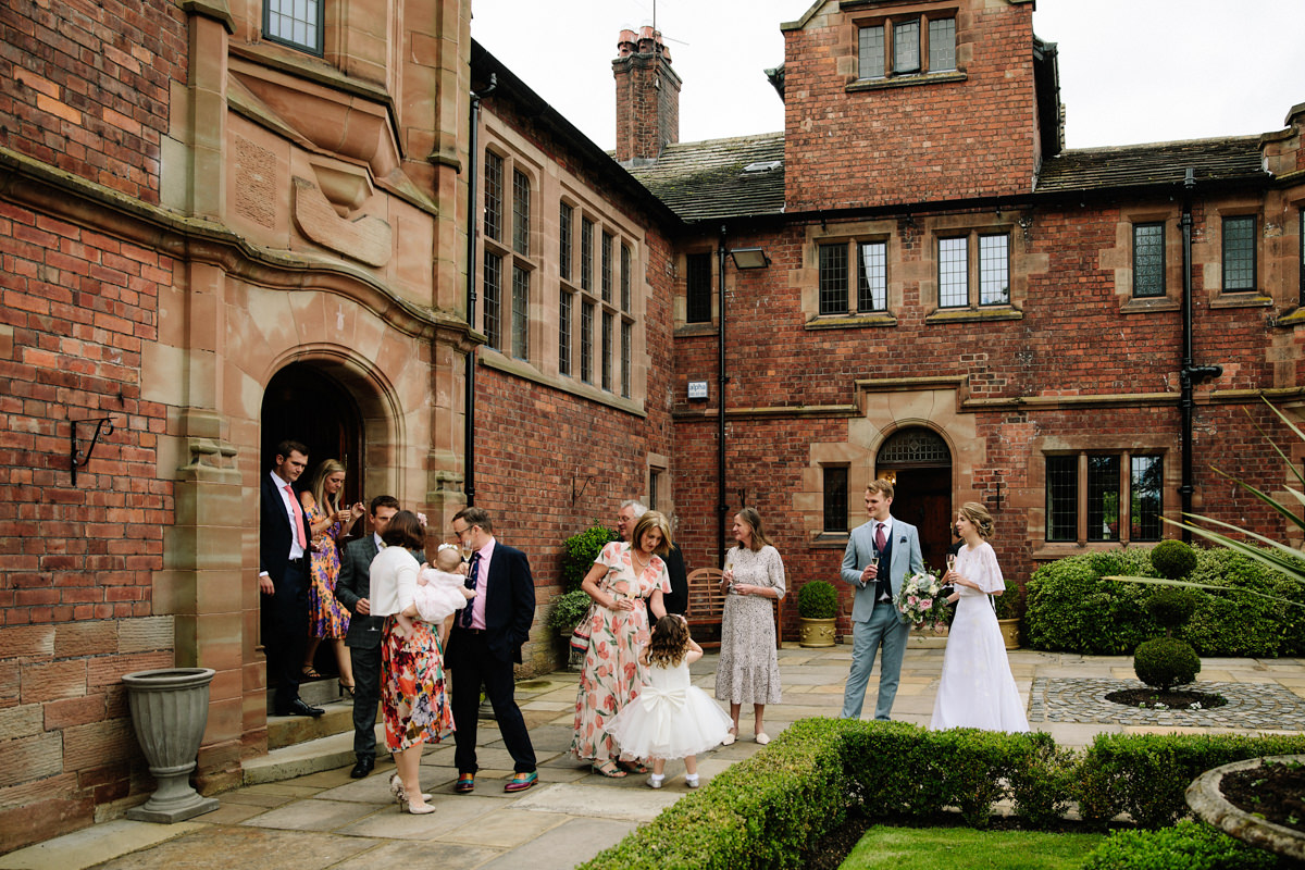 Guests in the courtyard at Colshaw Hall with their drinks reception