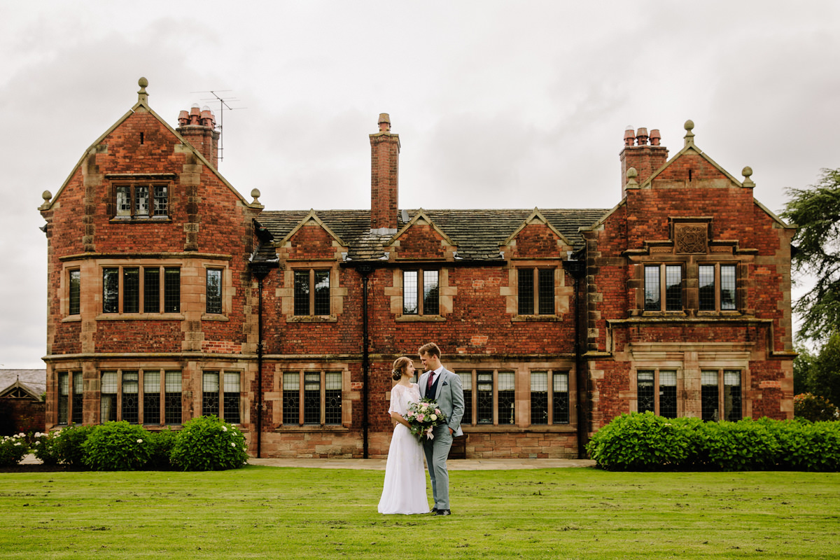 Bride and Groom in front of Colshaw Hall at their wedding