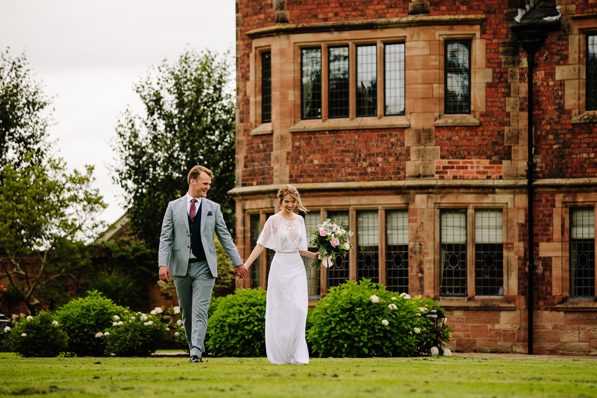 Bride and groom walking in the grounds of Colshaw Hall