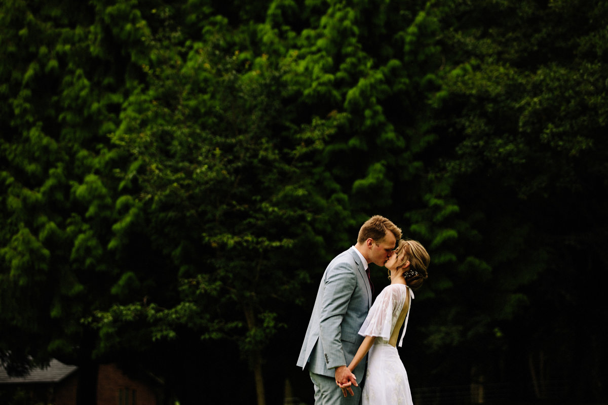 Intimate kiss between the bride and groom at Colshaw Hall wedding