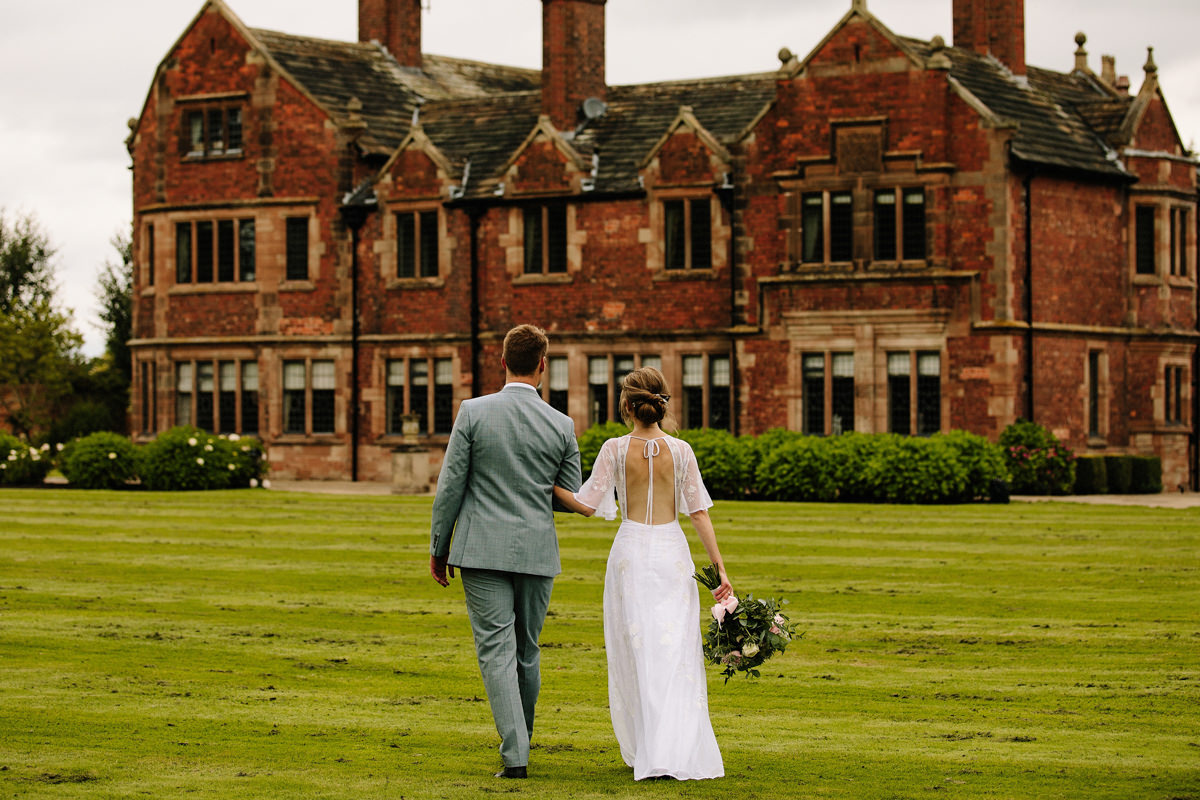 Colshaw Hall wedding photo with the bride and Groom walking