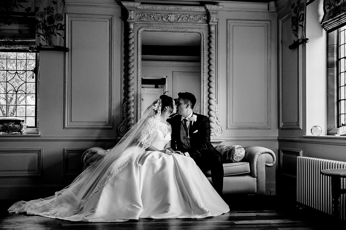 Black and white wedding photograph inside Colshaw Hall of the Bride and Groom
