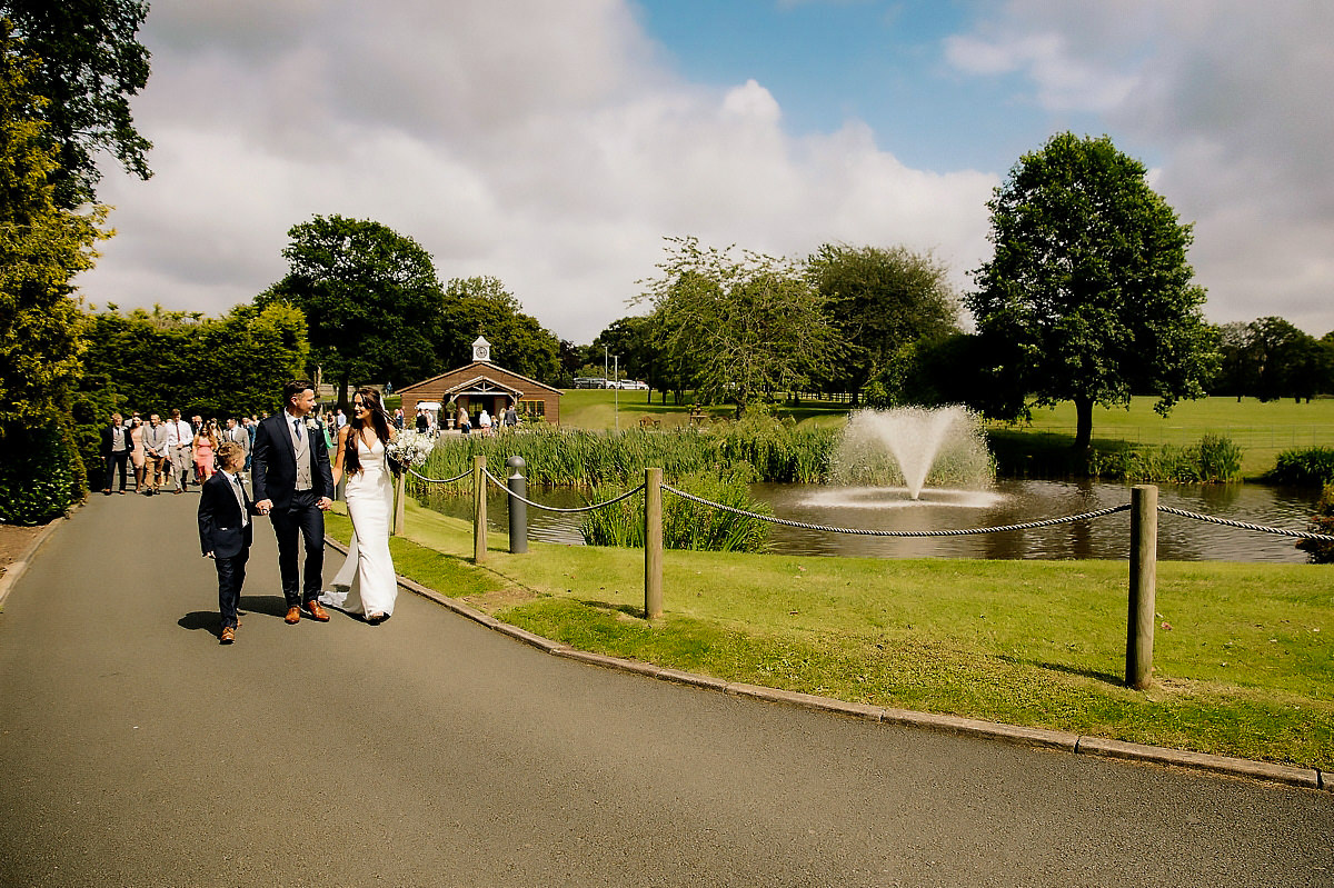 Bridal party walking from the Stables to the Pavillion