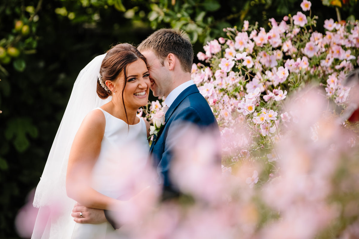 Bride and Groom with flowers at Heaton House Farm