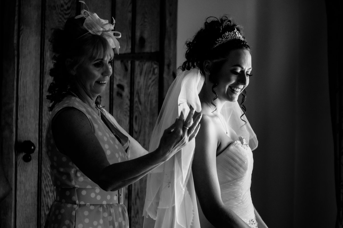 Mother of the bride helping with the wedding veil