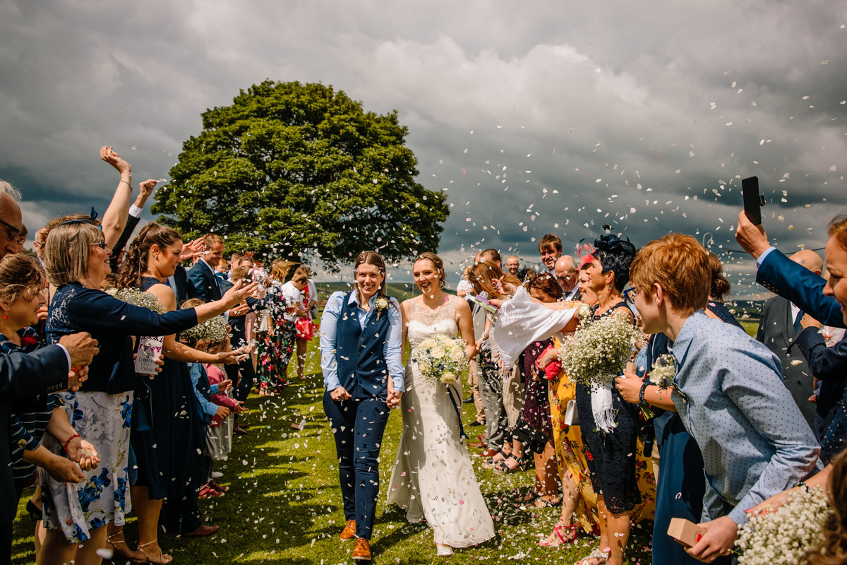 Confetti in front of the sycamore tree with the Bride and Bride