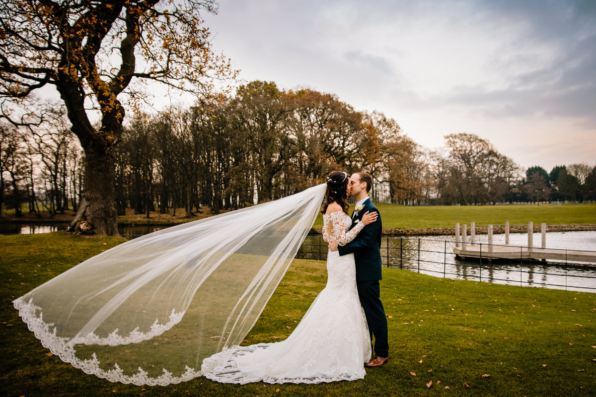 Bride and Groom with long veil blowing in the wind