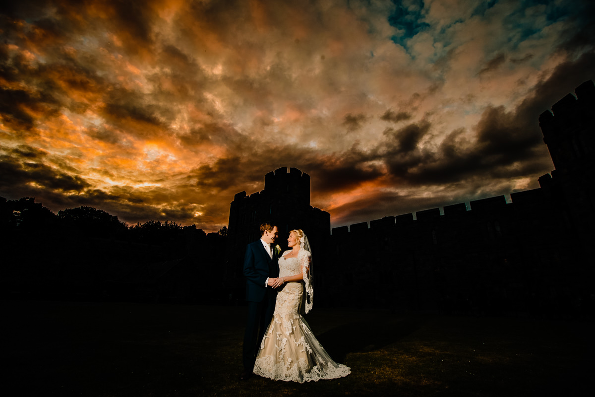 Sunset over Peckforton Castle with the bride and groom