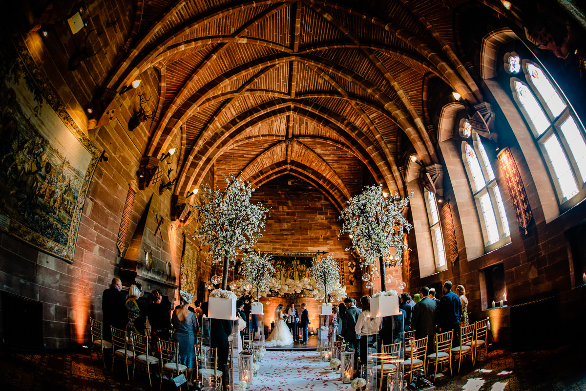 Wedding ceremony taking place in the Great Hall at Peckforton Castle