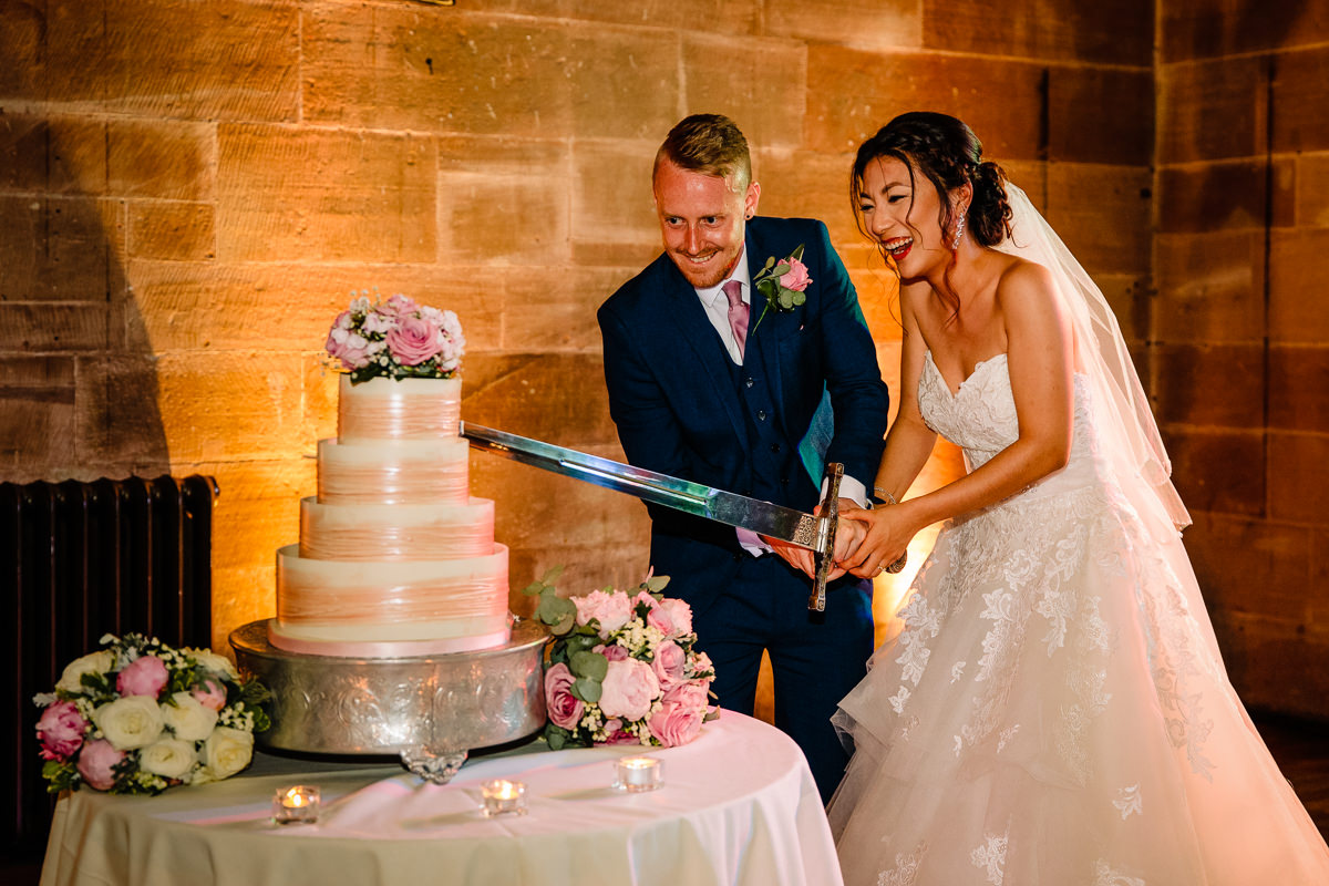 Wedding Cake cutting fun with a sword at Peckforton Castle