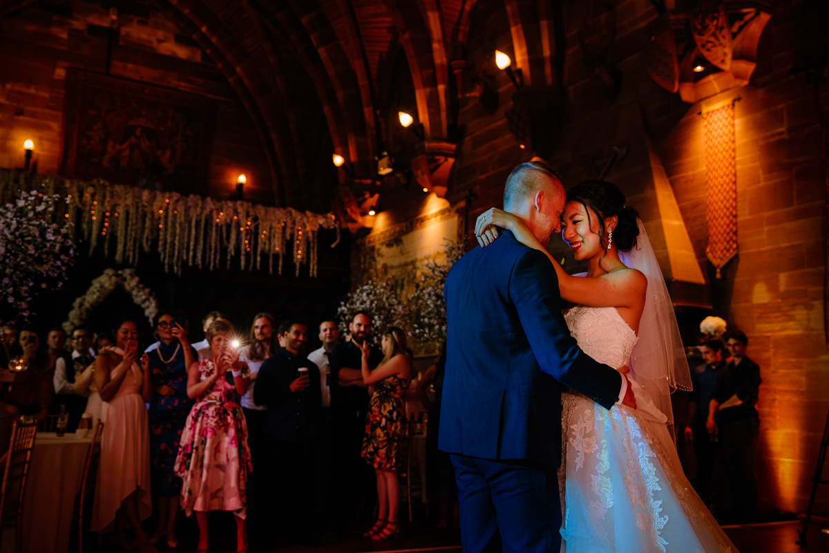 Intimate moment between the bride and groom during their first dance at Peckforton Castle in the Great Hall