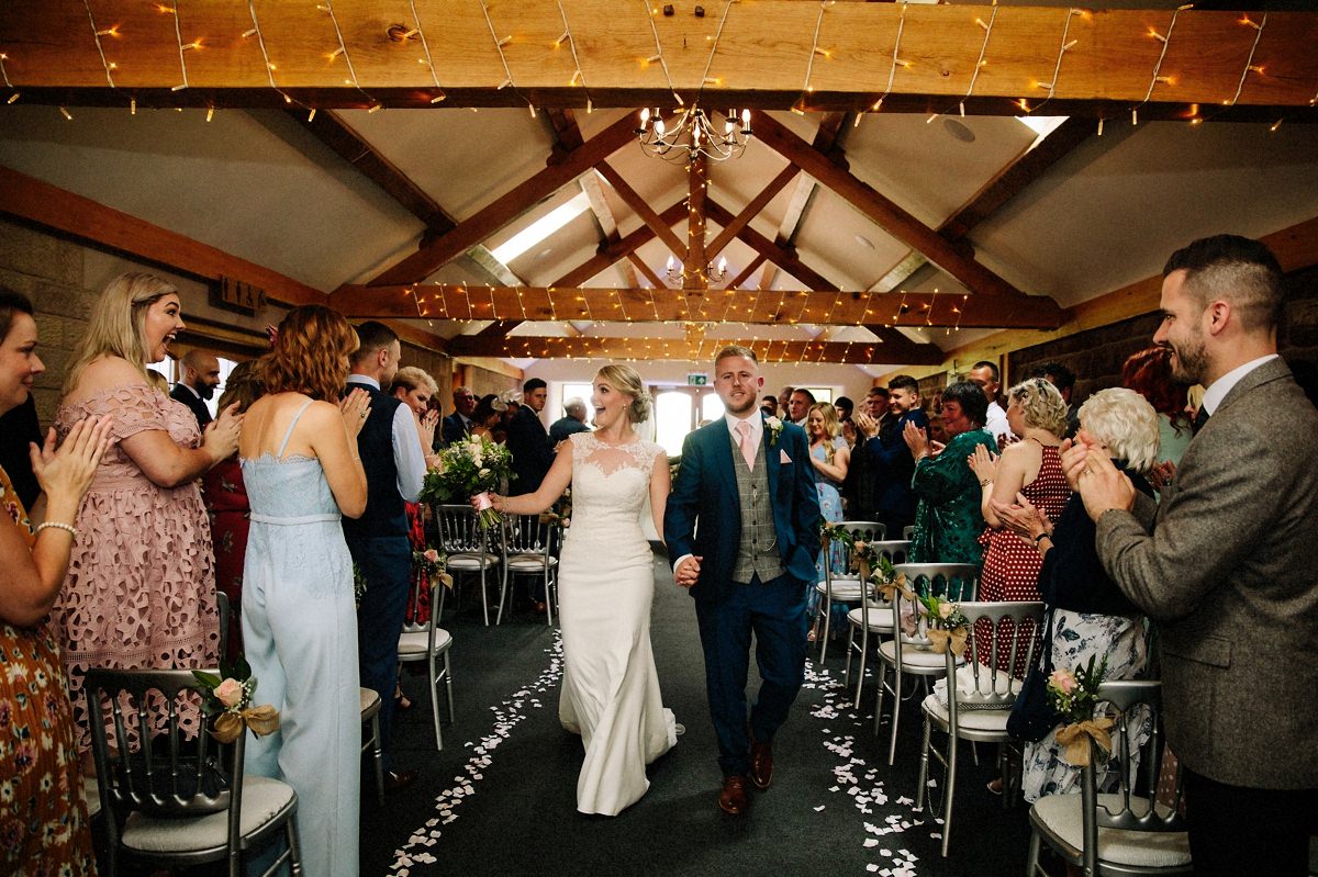 Bride and Groom walking down the aisle