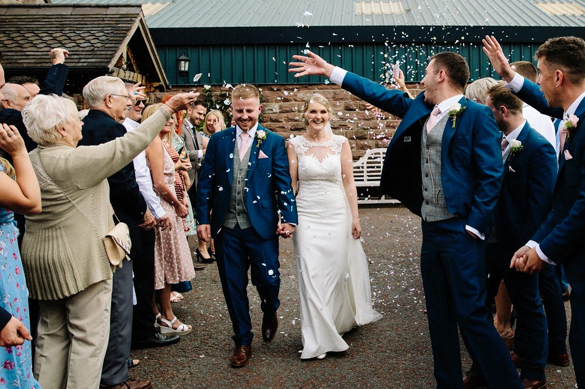 Confetti being thrown at the bride and groom at Heaton House Farm