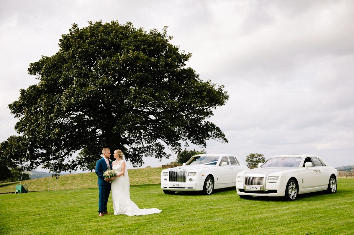 Heaton House Farm with the bride and groom and two wedding cars