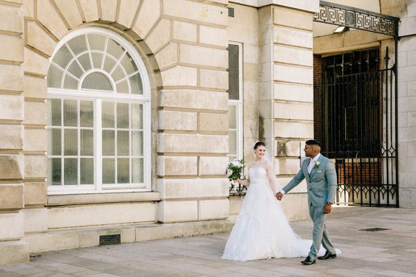 Bride & Groom walking hand in hand in Liverpool