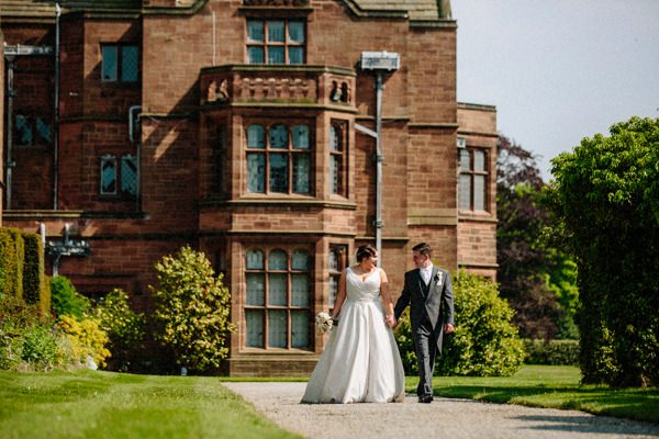 Thornton Manor wedding with the Bride and Groom walking in the gardens