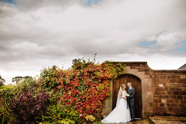 Autumnal Heaton House Farm wedding with the bride and groom holding each other