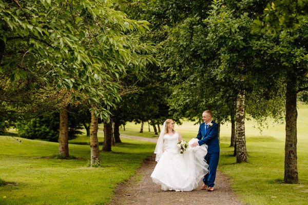 Bride and Groom walking together at Hartford Golf Club wedding venue in Cheshire