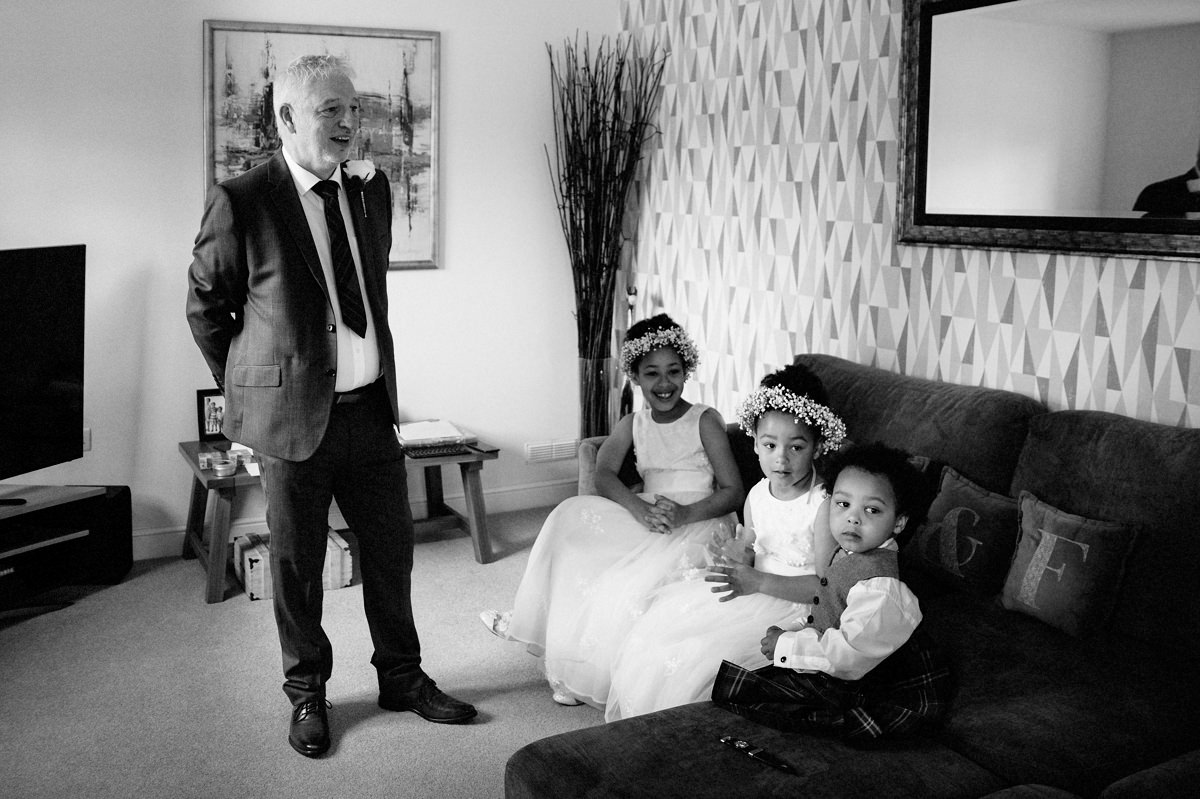 Dad, Flower Girls and Page boy waiting for the Bride in black & white