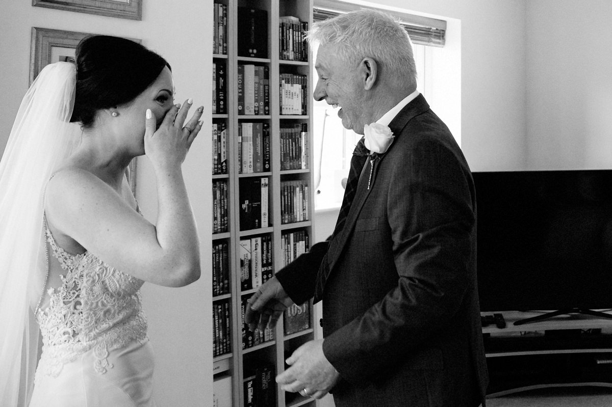 Bride with happy tears after seeing her dad on the morning of the wedding