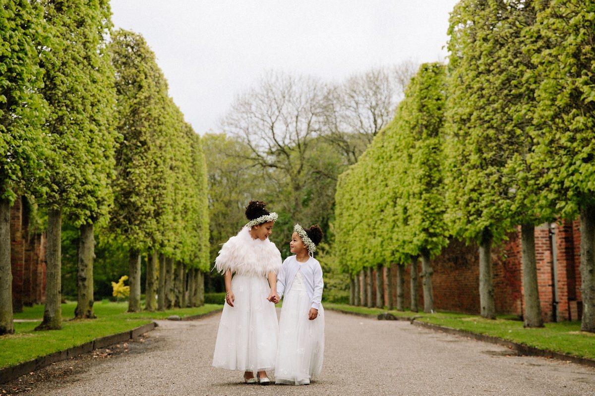 Lovely Flower girls holding hands at Arley Hall Gardens