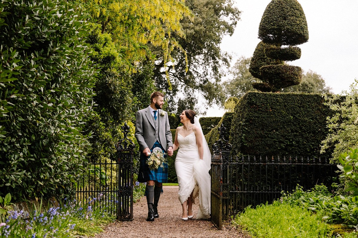 Bride and groom making their way back to the wedding guests for their drinks reception