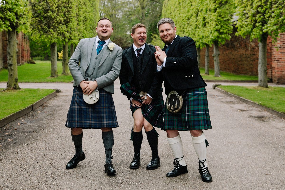 Grooms men in kilts having fun