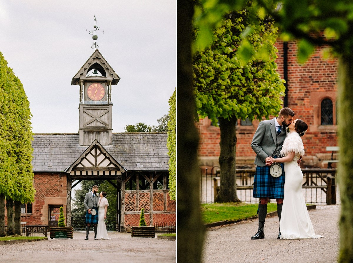 Bride and groom in front of the clock tower at Arley Hall