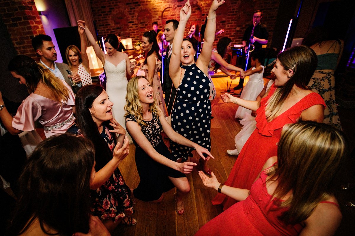 Wedding guests having lots of fun on the dance floor at Arley Hall in the Olympia room