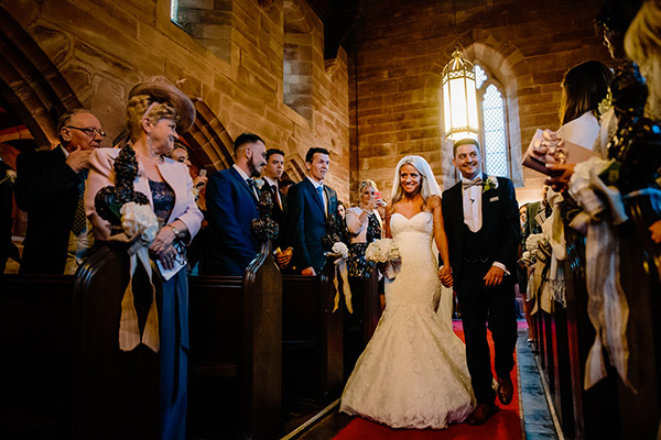 The Chapel at Peckforton Castle during a ceremony with the bride and groom walking down the aisle