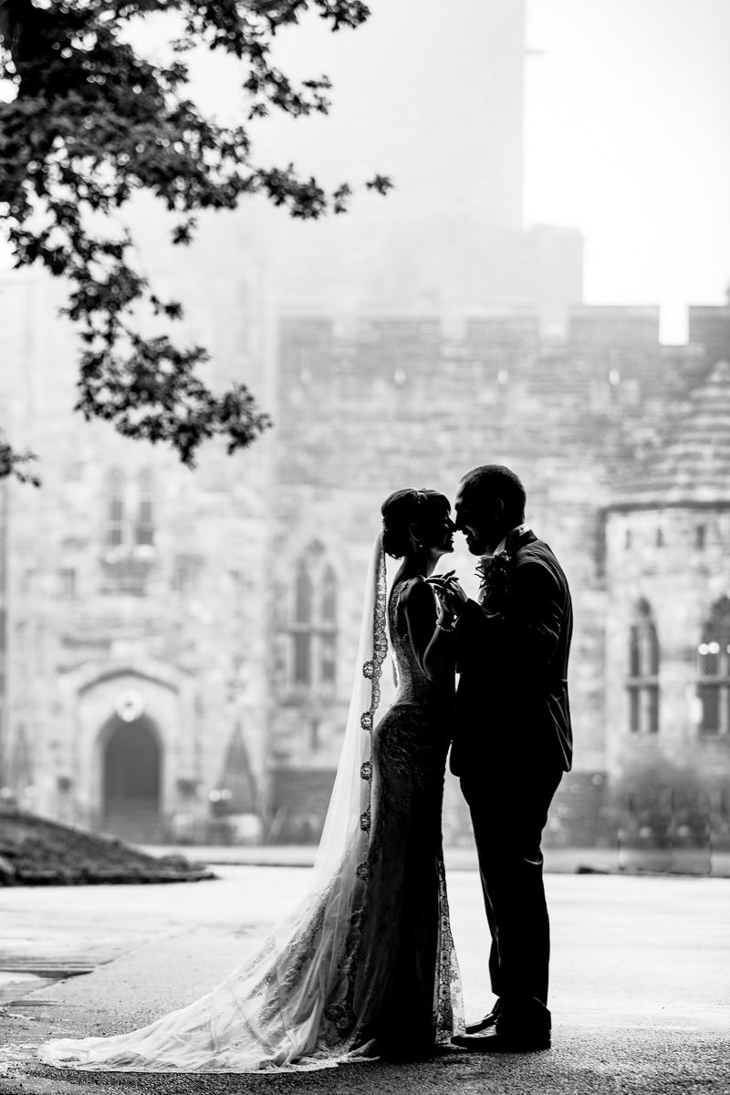 Silhouette of the bride and groom on a misty day at Peckforton Castle