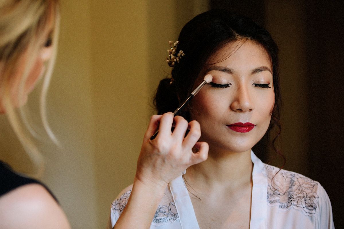 Bride having her make up applied before she gets married