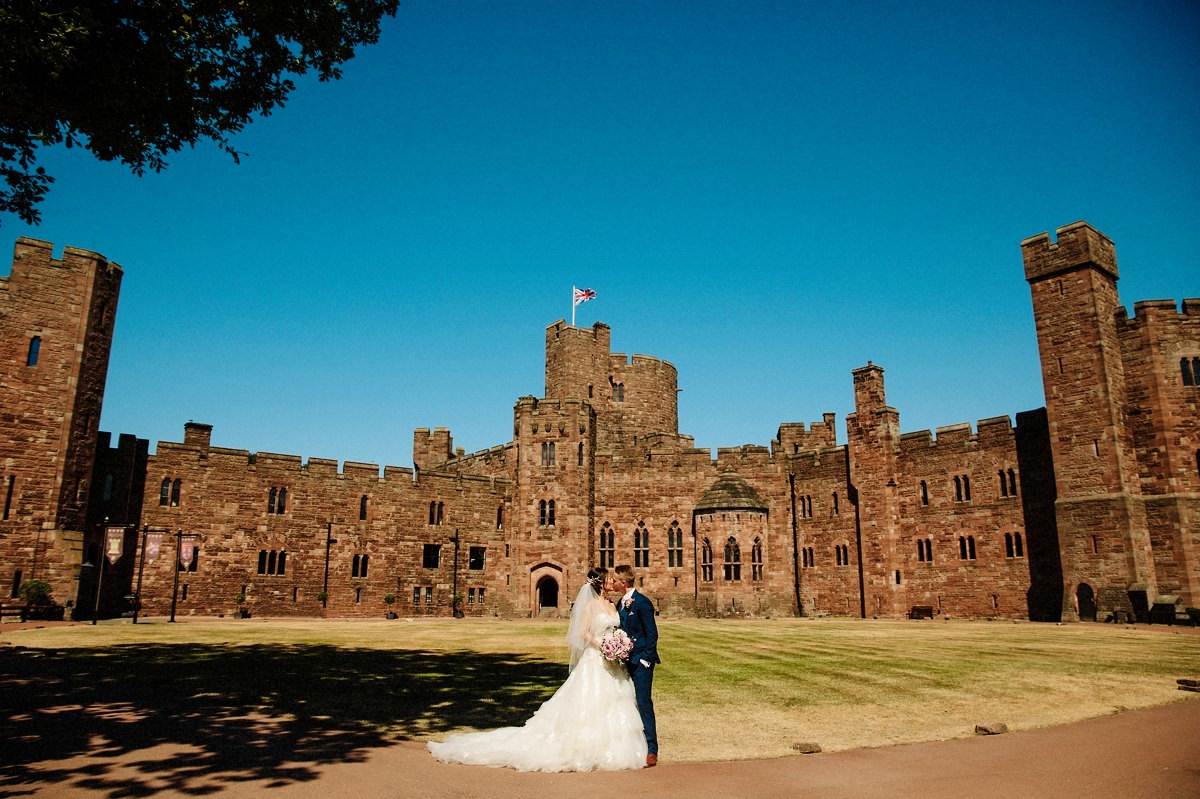 Peckforton Castle on a beautiful sunny day with the bride and groom