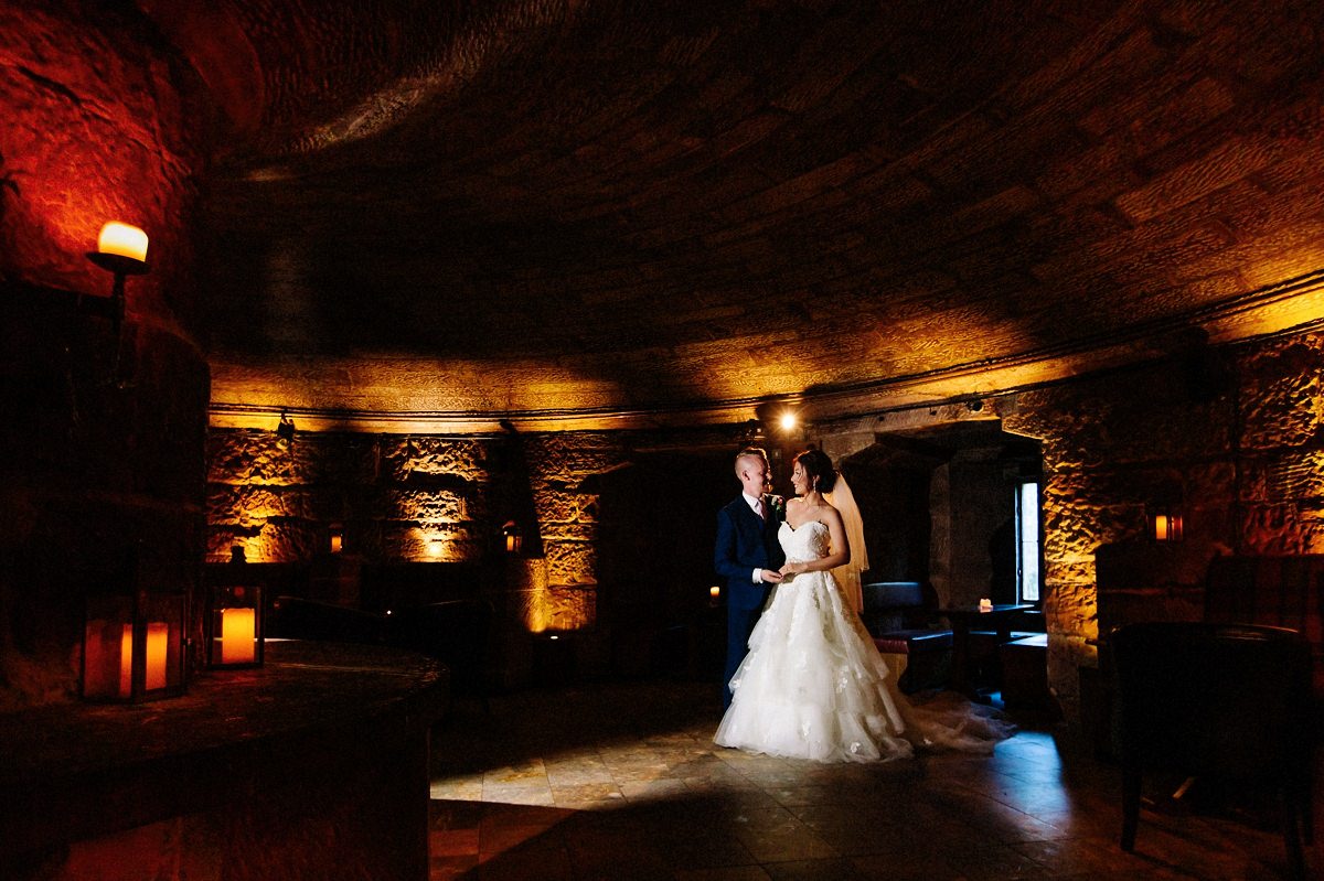 The Wine Cellar at Peckforton Castle with the bride and groom