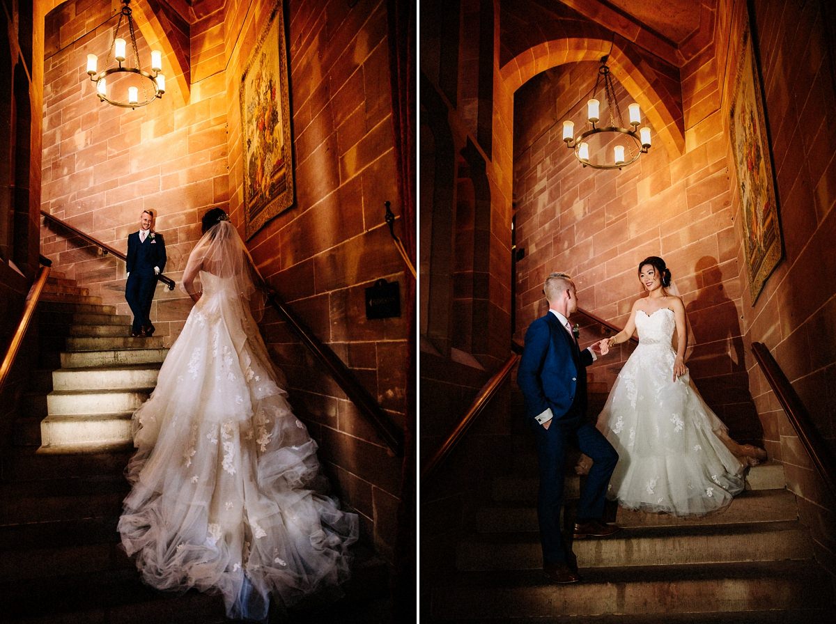 The gorgeous staircase at Peckforton Castle with the bride and groom